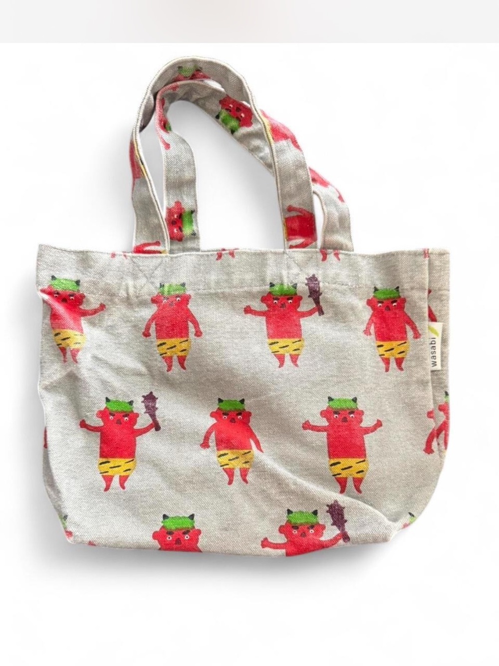 WASABI mini canvas tote. Features red “oni” print. Gray canvas